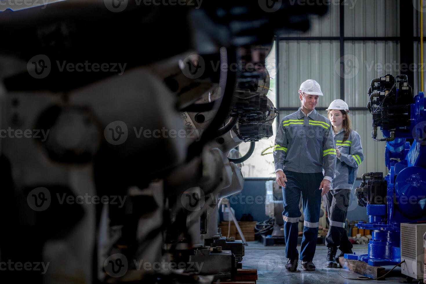 engineers check control heavy machine robot arm. Diverse Team of Industrial Robotics Engineers Gathered Around Machine. Professional Machinery Operators repair electric robot on bright digital panel. photo