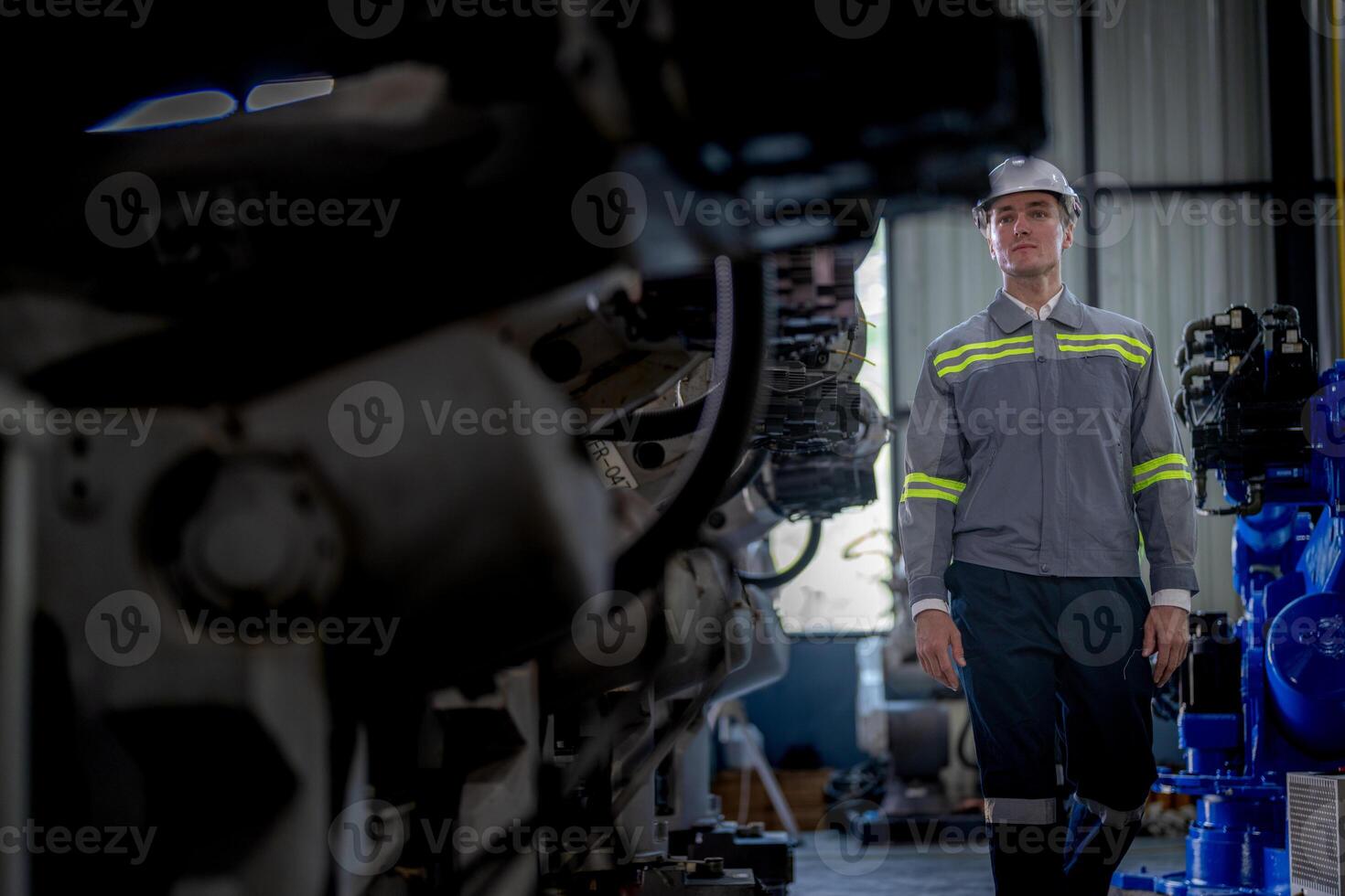 Factory engineer woman inspecting on machine with smart tablet. Worker works at machine robot arm. The welding machine with a remote system in an industrial factory. Artificial intelligence concept. photo