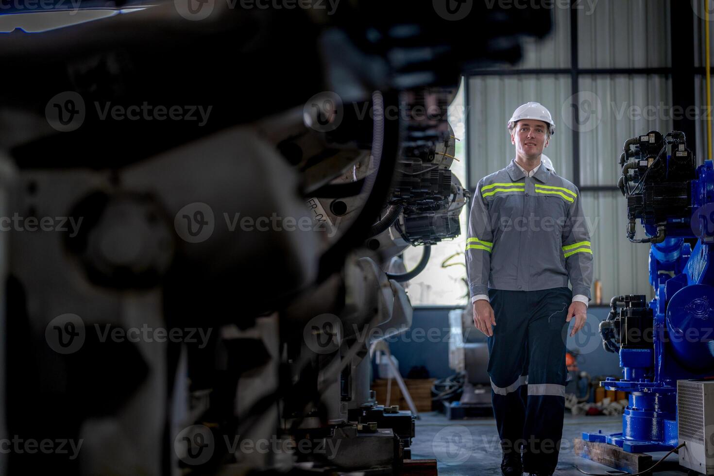 Factory engineer woman inspecting on machine with smart tablet. Worker works at machine robot arm. The welding machine with a remote system in an industrial factory. Artificial intelligence concept. photo