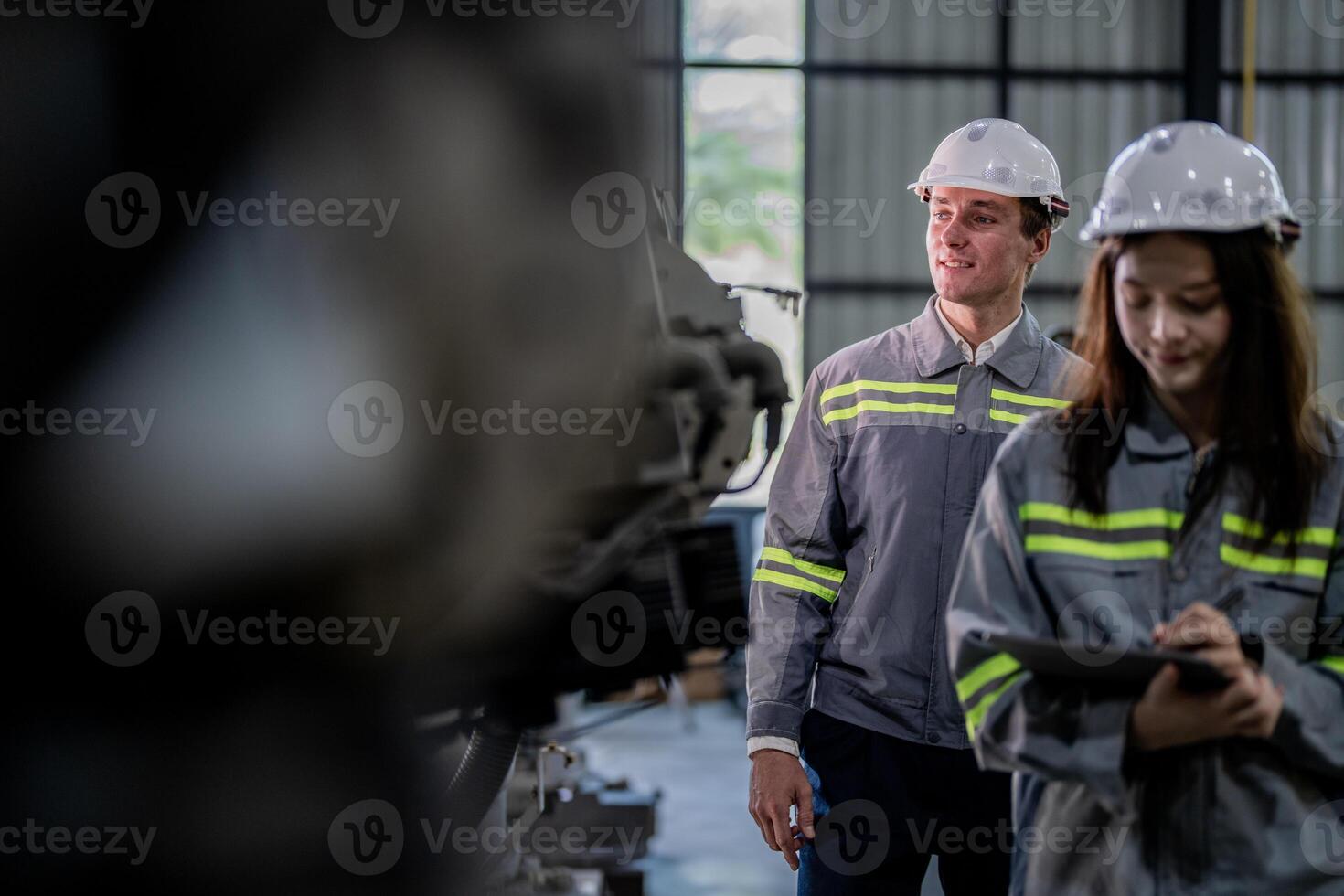 engineers check control heavy machine robot arm. Diverse Team of Industrial Robotics Engineers Gathered Around Machine. Professional Machinery Operators repair electric robot on bright digital panel. photo