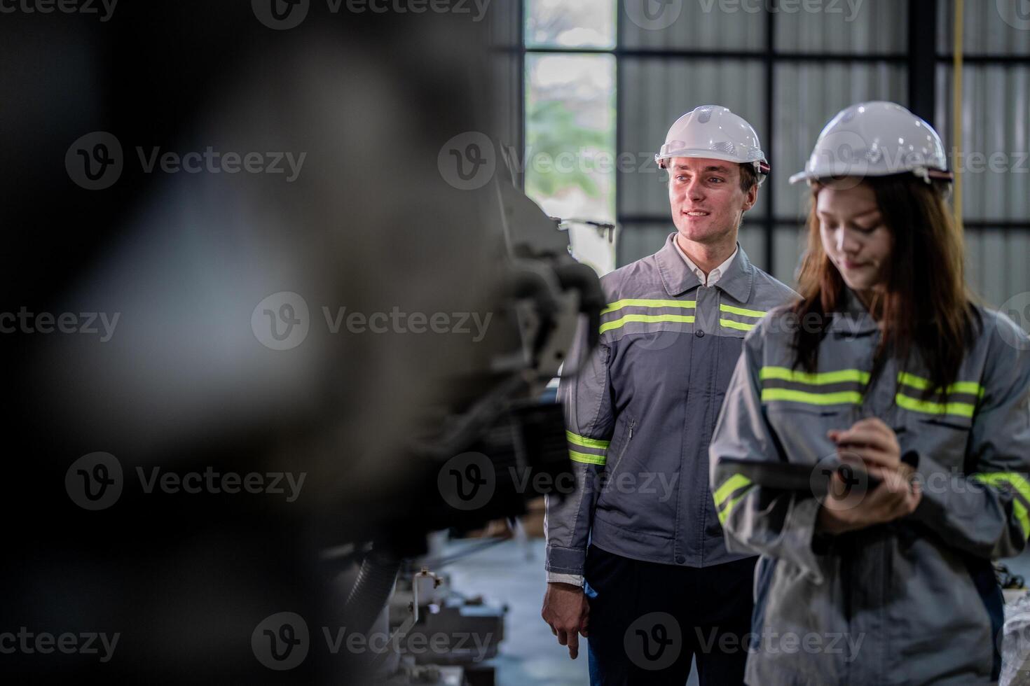 engineers check control heavy machine robot arm. Diverse Team of Industrial Robotics Engineers Gathered Around Machine. Professional Machinery Operators repair electric robot on bright digital panel. photo