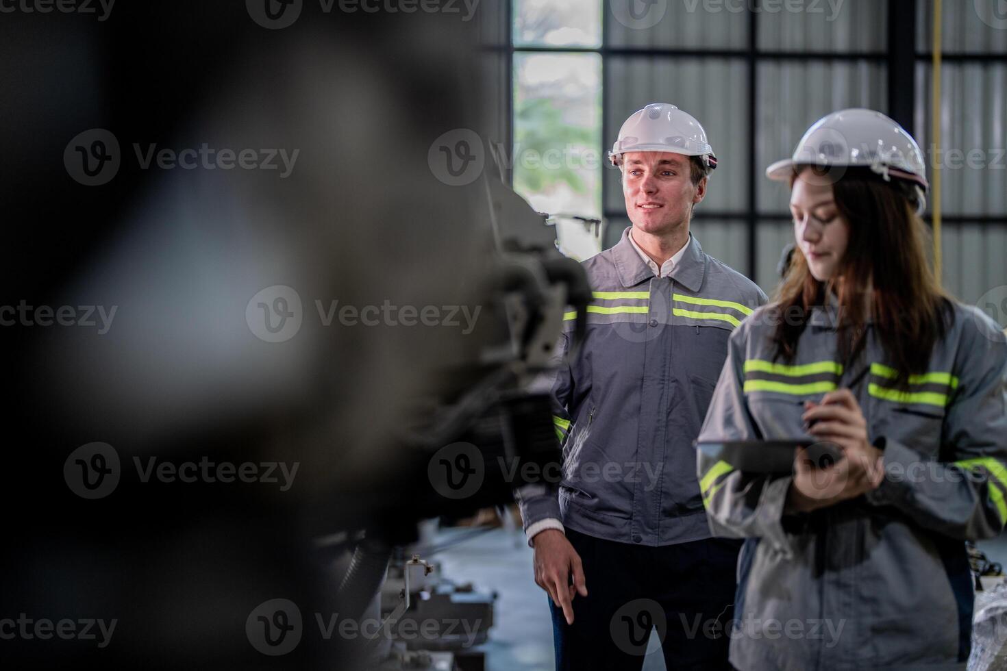 engineers check control heavy machine robot arm. Diverse Team of Industrial Robotics Engineers Gathered Around Machine. Professional Machinery Operators repair electric robot on bright digital panel. photo