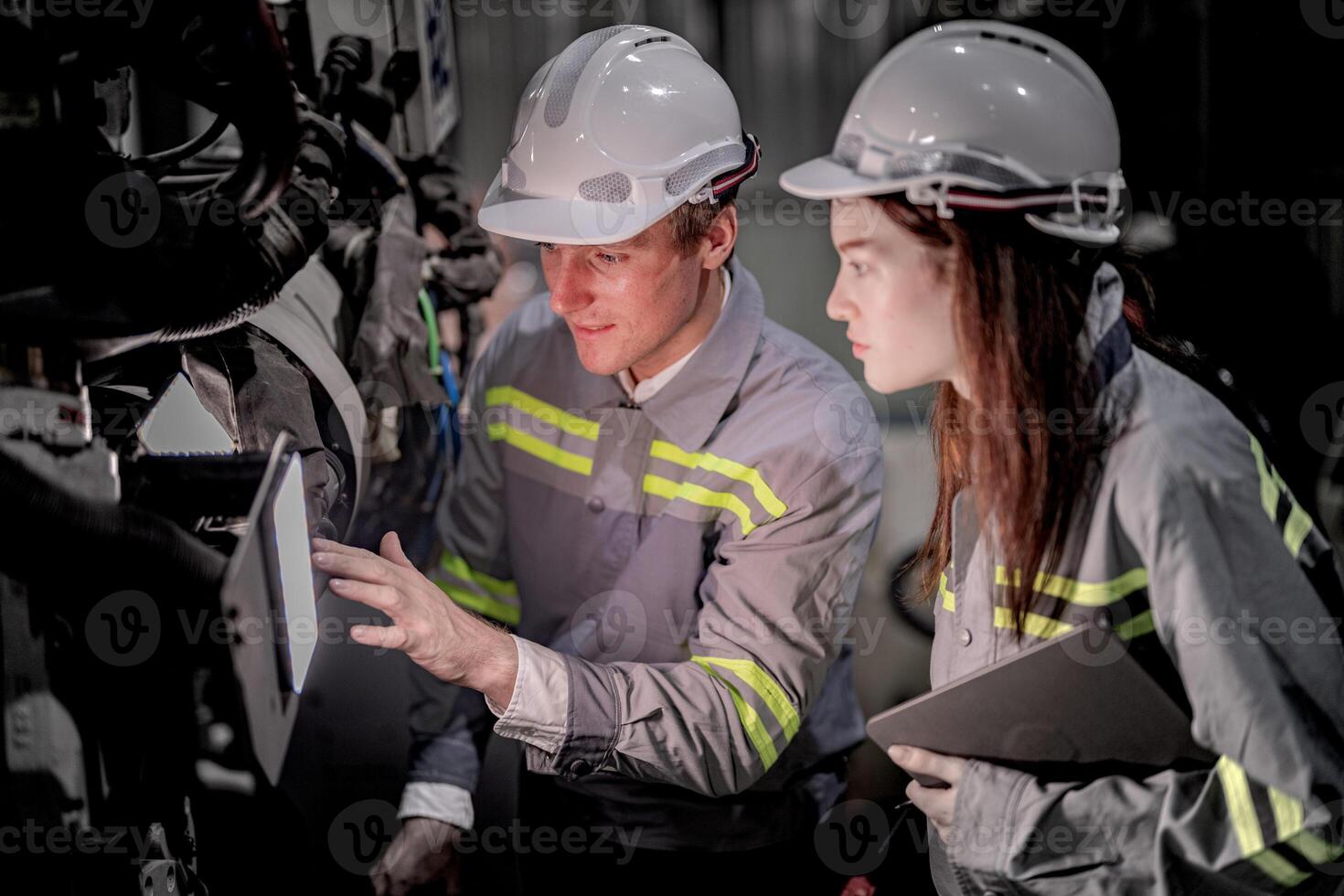 Sales manager and factory owner in suits negotiating selling robots used in the factory. Business engineers meeting and checking new machine robot. Workers walking at warehouse welding machine. photo