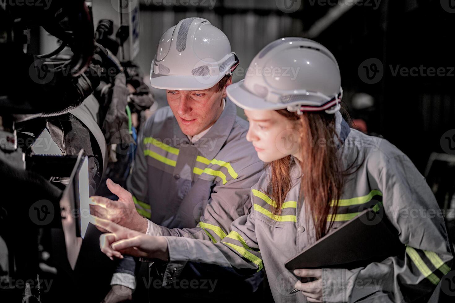 Sales manager and factory owner in suits negotiating selling robots used in the factory. Business engineers meeting and checking new machine robot. Workers walking at warehouse welding machine. photo