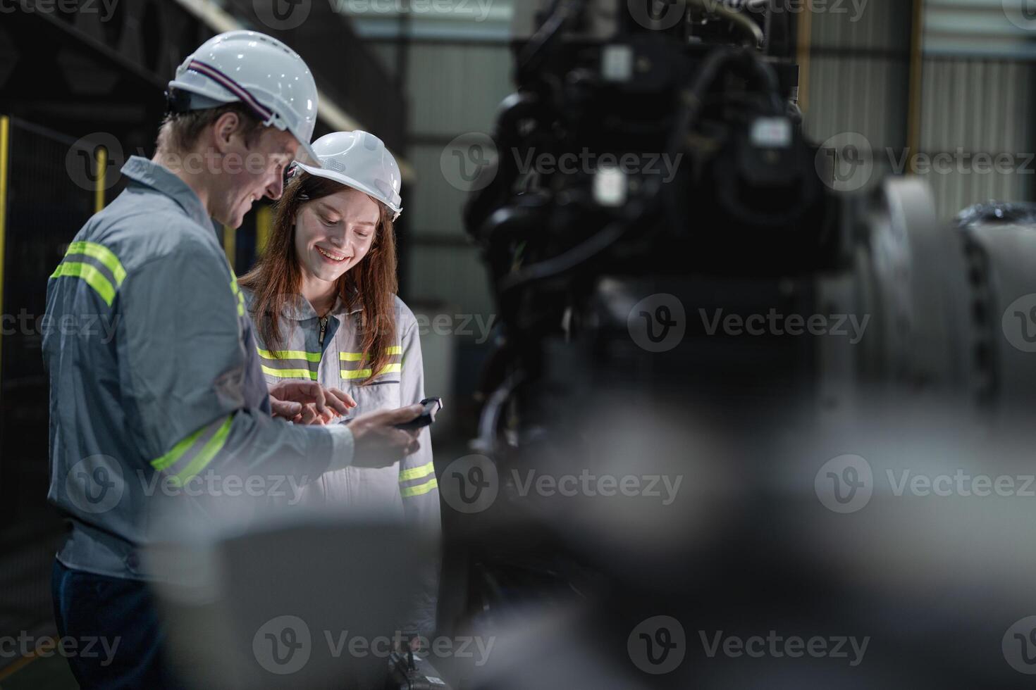 engineers check control heavy machine robot arm. Diverse Team of Industrial Robotics Engineers Gathered Around Machine. Professional Machinery Operators repair electric robot on bright digital panel. photo