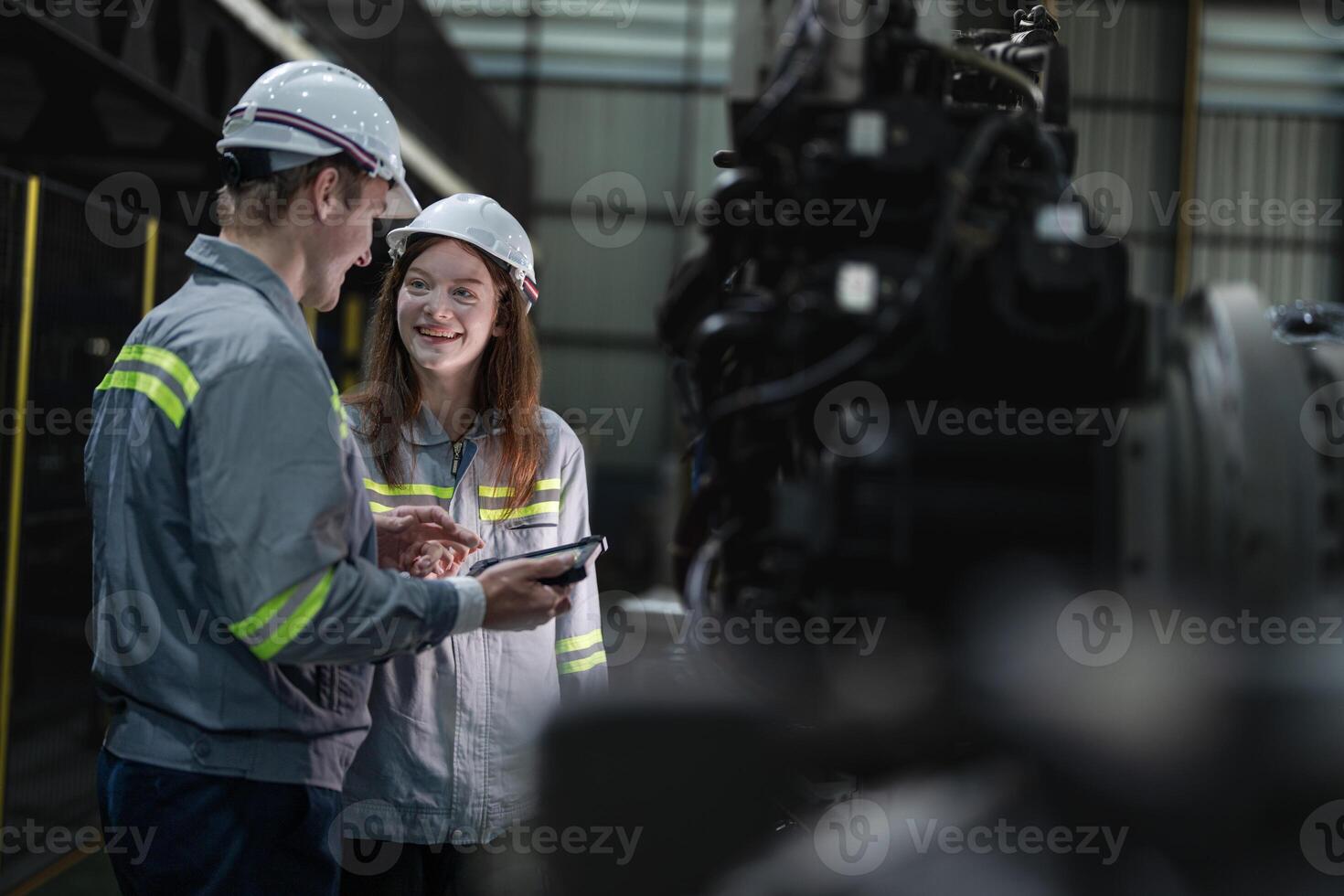 engineers check control heavy machine robot arm. Diverse Team of Industrial Robotics Engineers Gathered Around Machine. Professional Machinery Operators repair electric robot on bright digital panel. photo