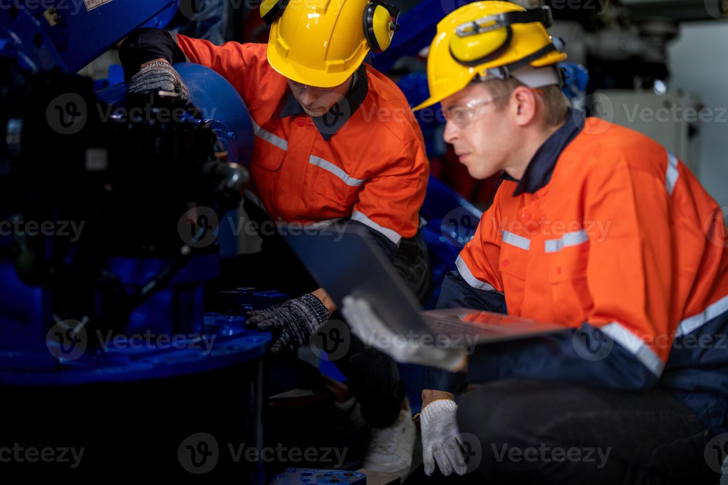 Business engineers meet and check control heavy machine robot arm. Diverse Team of Industrial Robotics Engineers Gathered Around machine. Professional Machinery Operator Use Industrial Digital Tablet. photo