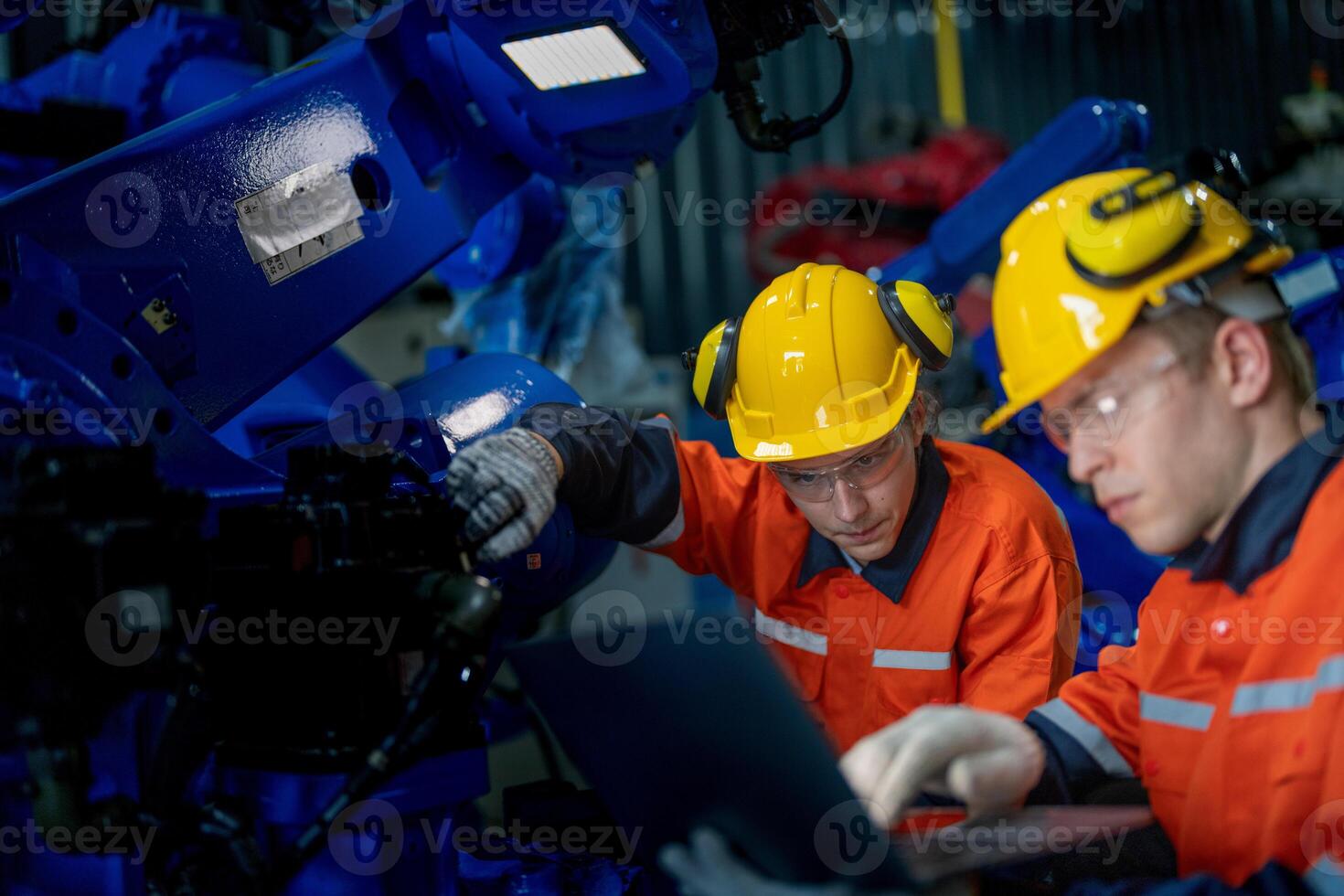 Business engineers meet and check control heavy machine robot arm. Diverse Team of Industrial Robotics Engineers Gathered Around machine. Professional Machinery Operator Use Industrial Digital Tablet. photo
