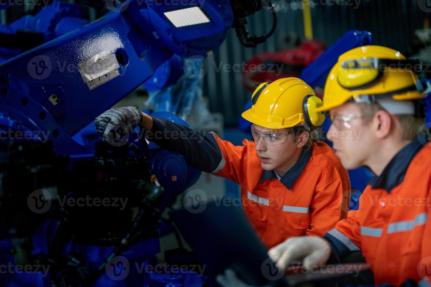 Business engineers meet and check control heavy machine robot arm. Diverse Team of Industrial Robotics Engineers Gathered Around machine. Professional Machinery Operator Use Industrial Digital Tablet. photo