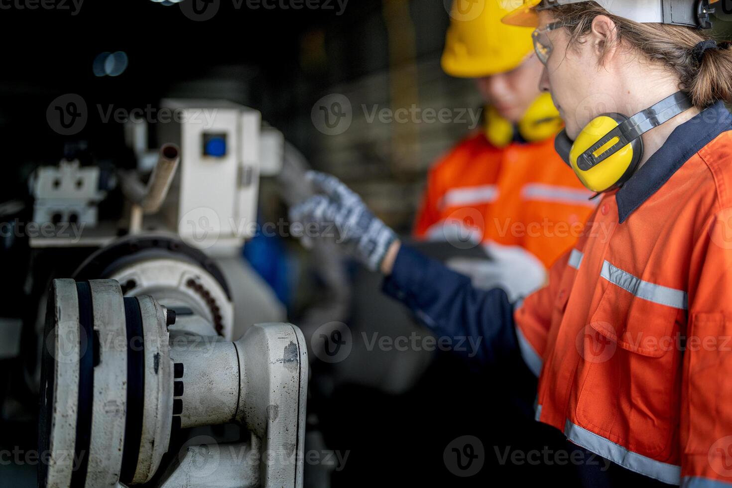 male engineer workers maintenance automatic robotic arm machine in a factory. worker checking and repairing automatic robot hand machine. technician worker check for repair factory machine. photo