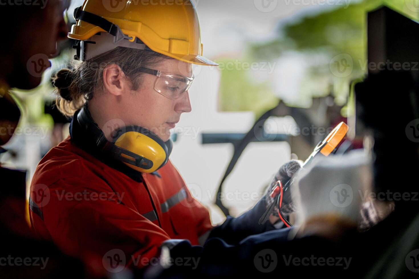male engineer workers maintenance automatic robotic arm machine in a factory. worker checking and repairing automatic robot hand machine. technician worker check for repair factory machine. photo