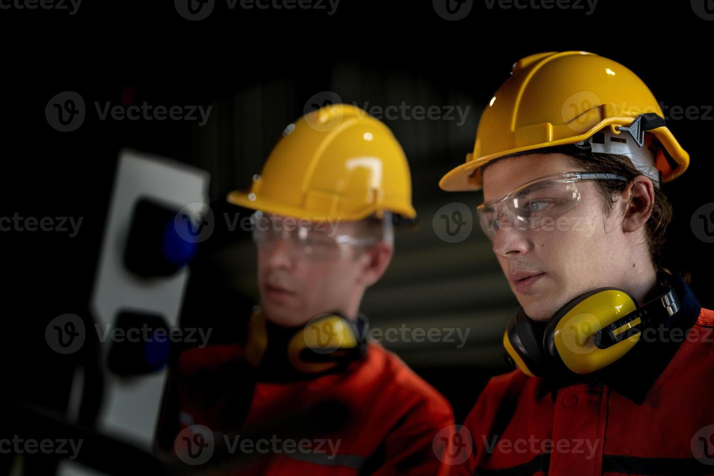 male engineer workers maintenance automatic robotic arm machine in a factory. worker checking and repairing automatic robot hand machine. technician worker check for repair factory machine. photo