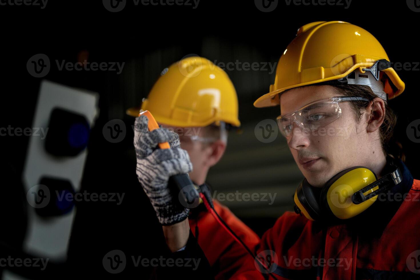 male engineer workers maintenance automatic robotic arm machine in a factory. worker checking and repairing automatic robot hand machine. technician worker check for repair factory machine. photo