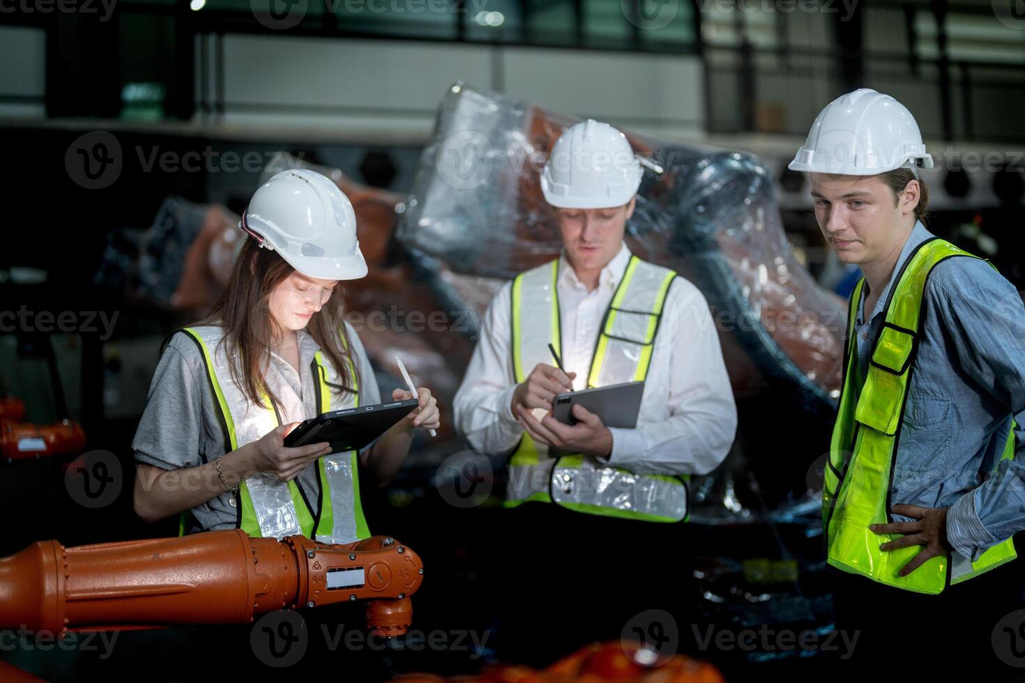 Sales manager and factory owner in suits negotiating selling robots used in the factory. Business engineers meeting and checking new machine robot. Workers walking at warehouse welding machine. photo