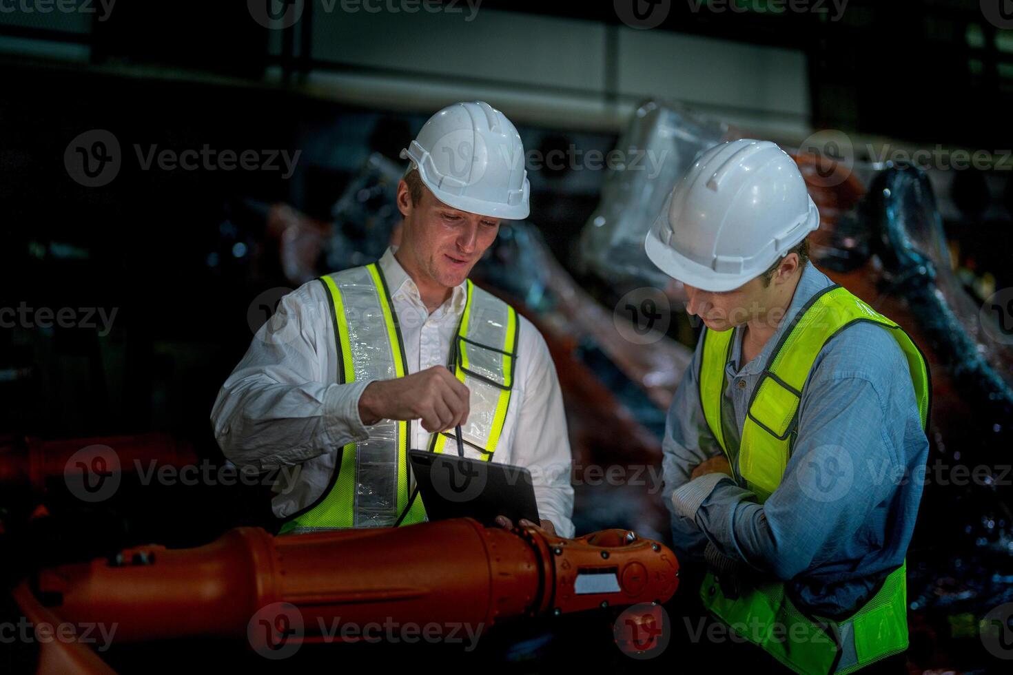Business engineers meeting and checking new machine robot. Workers walking at warehouse industry welding machine. business negotiation concepts and technology. women Using smart Tablet to present man. photo