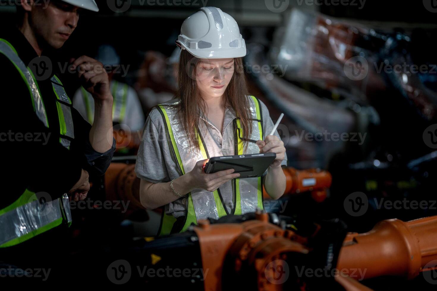Sales manager and factory owner in suits negotiating selling robots used in the factory. Business engineers meeting and checking new machine robot. Workers walking at warehouse welding machine. photo