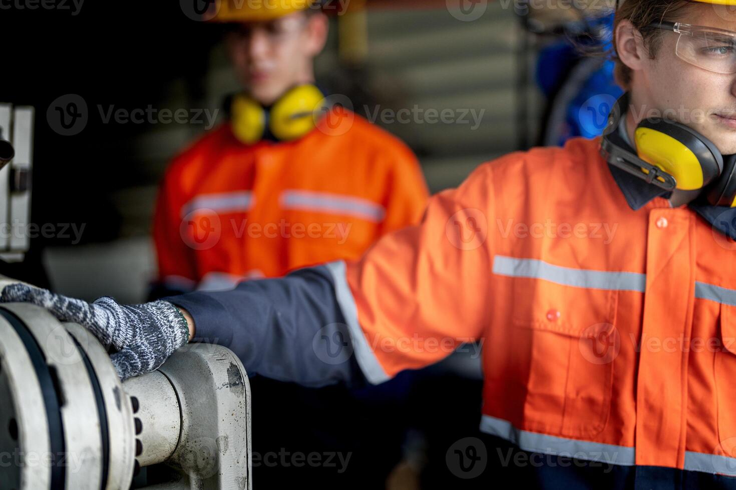 male engineer workers maintenance automatic robotic arm machine in a factory. worker checking and repairing automatic robot hand machine. technician worker check for repair factory machine. photo