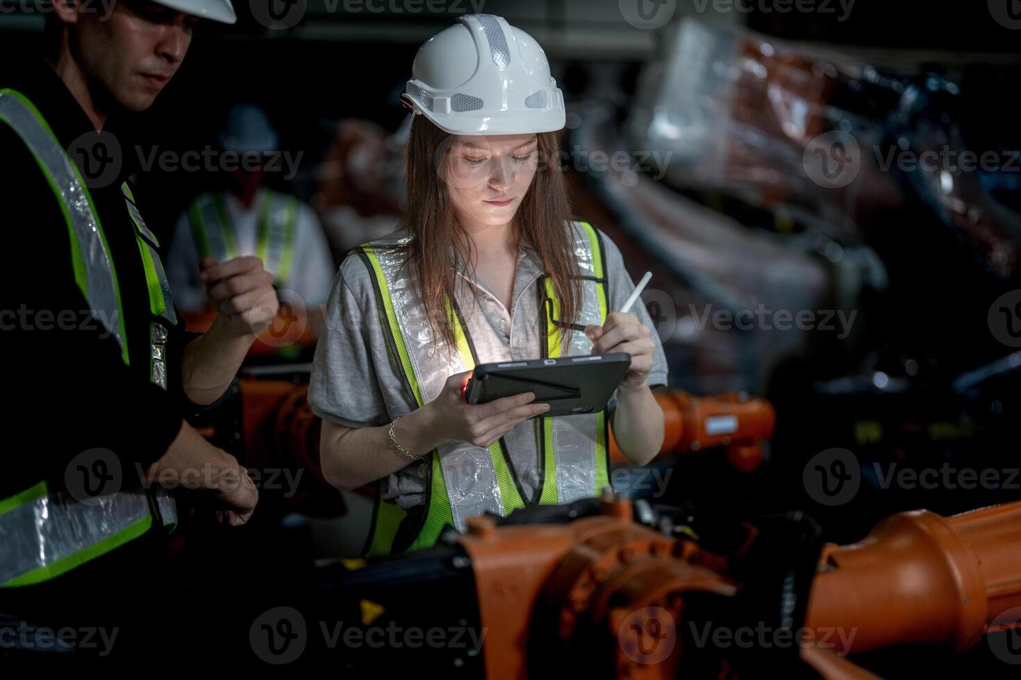 Sales manager and factory owner in suits negotiating selling robots used in the factory. Business engineers meeting and checking new machine robot. Workers walking at warehouse welding machine. photo