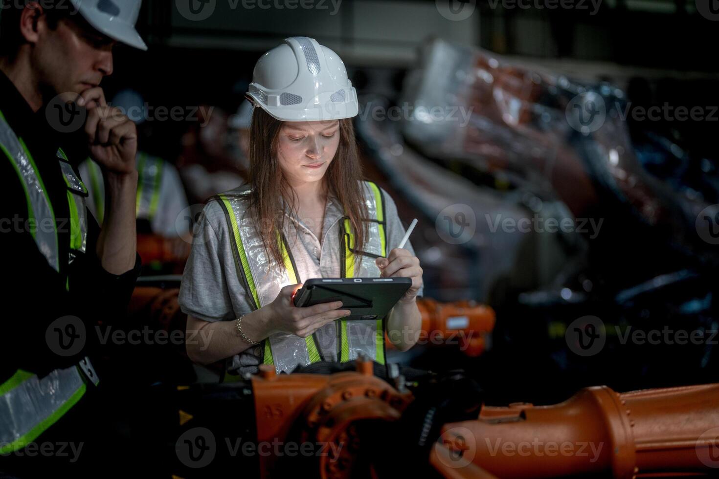 Sales manager and factory owner in suits negotiating selling robots used in the factory. Business engineers meeting and checking new machine robot. Workers walking at warehouse welding machine. photo