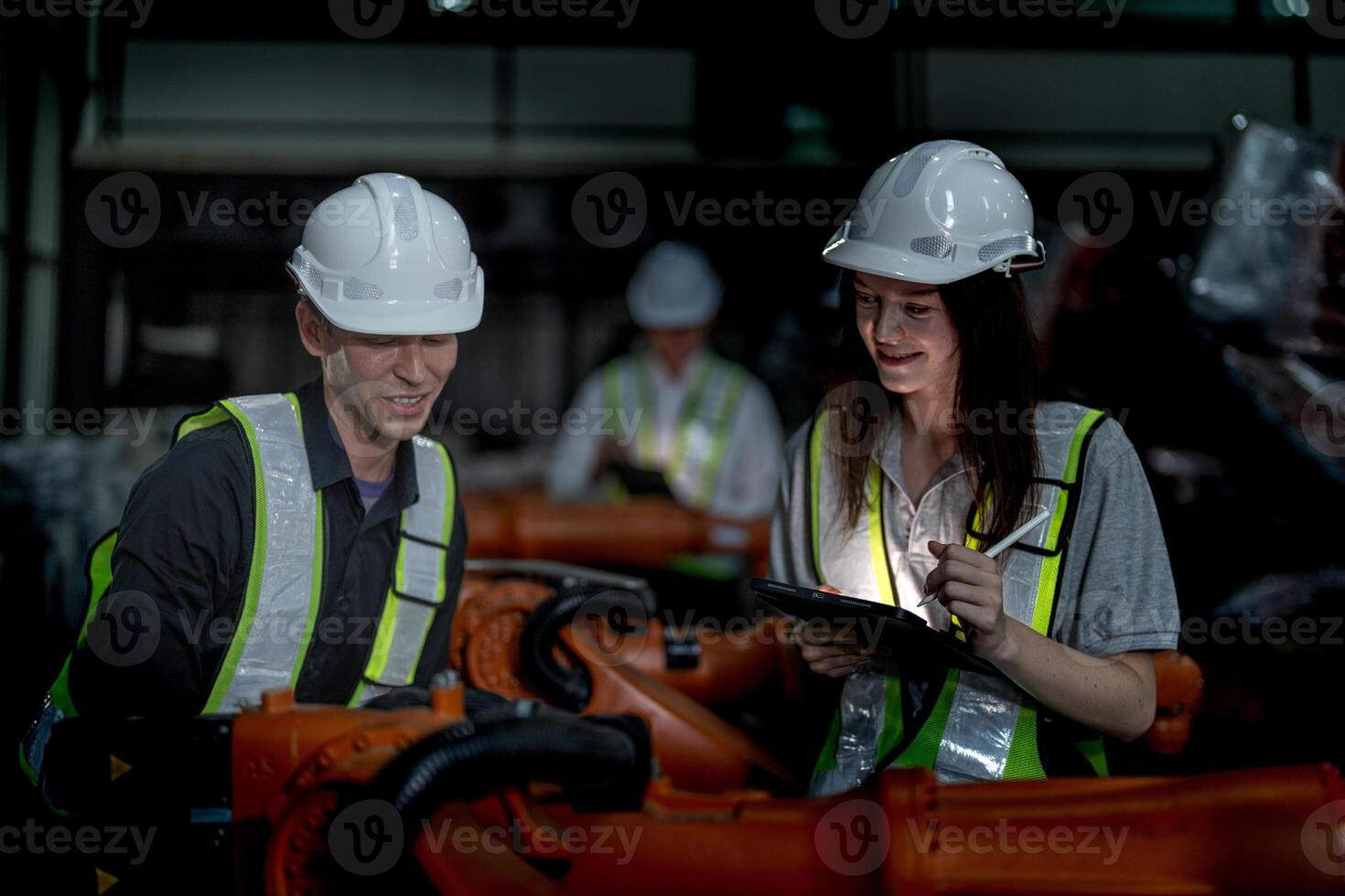 Sales manager and factory owner in suits negotiating selling robots used in the factory. Business engineers meeting and checking new machine robot. Workers walking at warehouse welding machine. photo