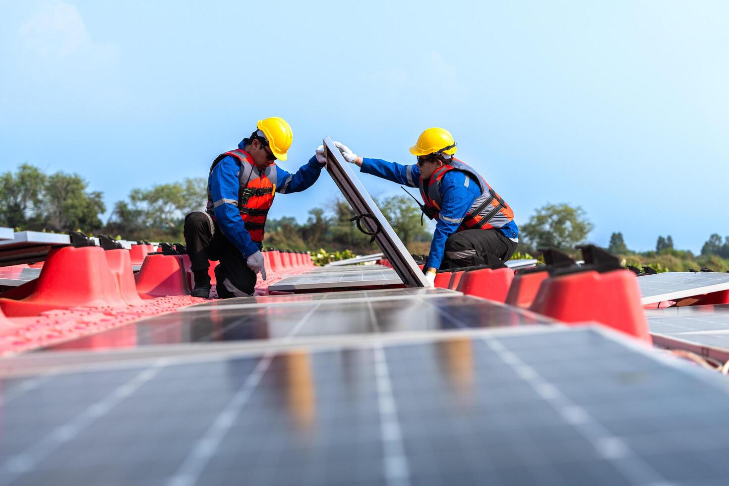 Male workers repair Floating solar panels on water lake. Engineers construct on site Floating solar panels at sun light. clean energy for future living. Industrial Renewable energy of green power. photo