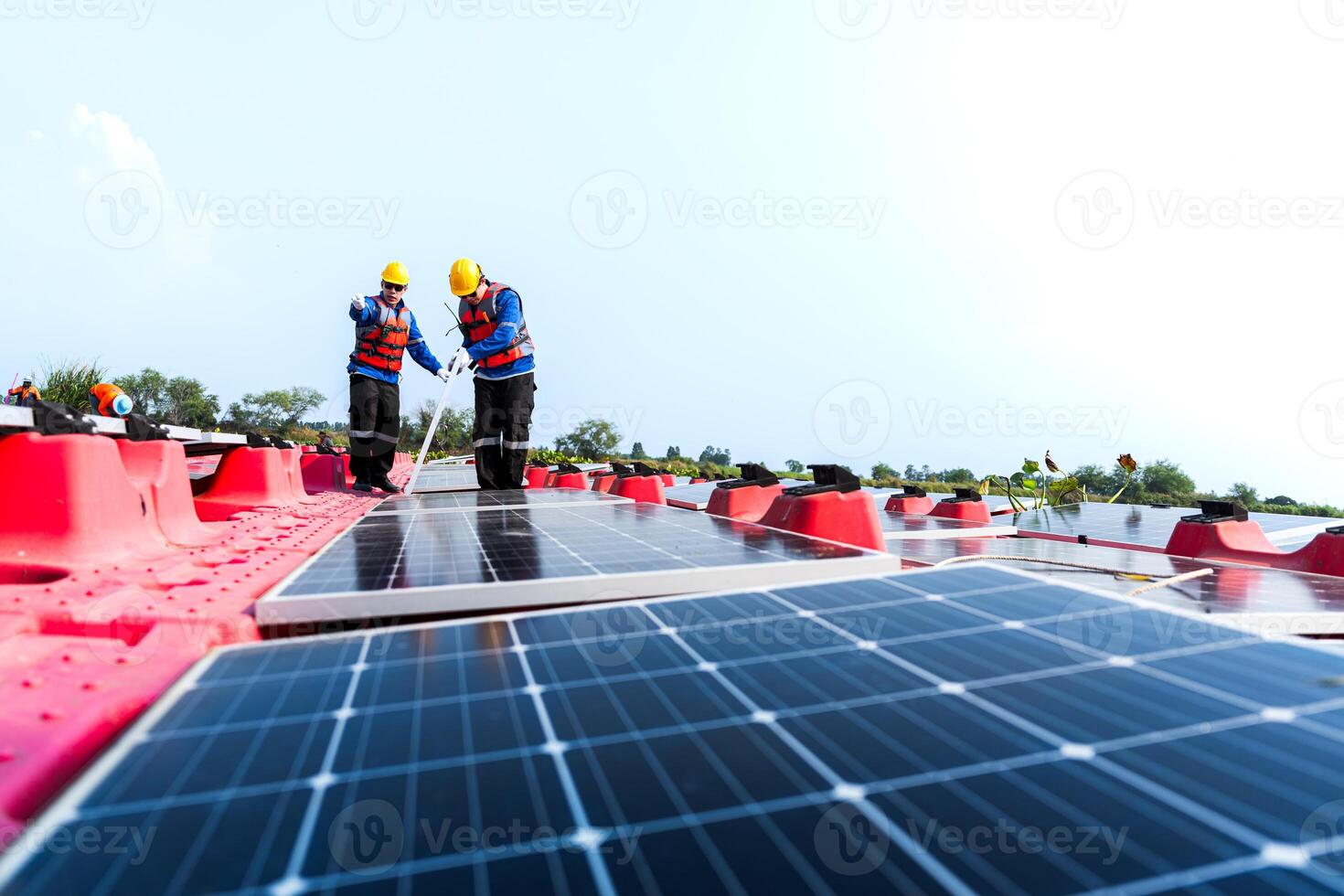 Male workers repair Floating solar panels on water lake. Engineers construct on site Floating solar panels at sun light. clean energy for future living. Industrial Renewable energy of green power. photo