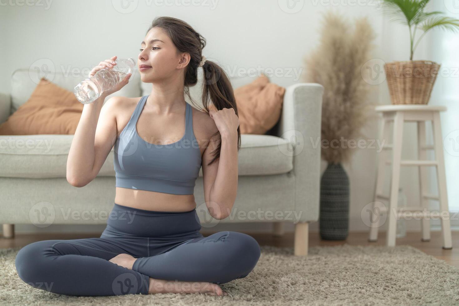 close up of Young face caucasian fitness woman wearing sport clothes training indoor drinking fresh water. healthy lifestyle and wellness. photo