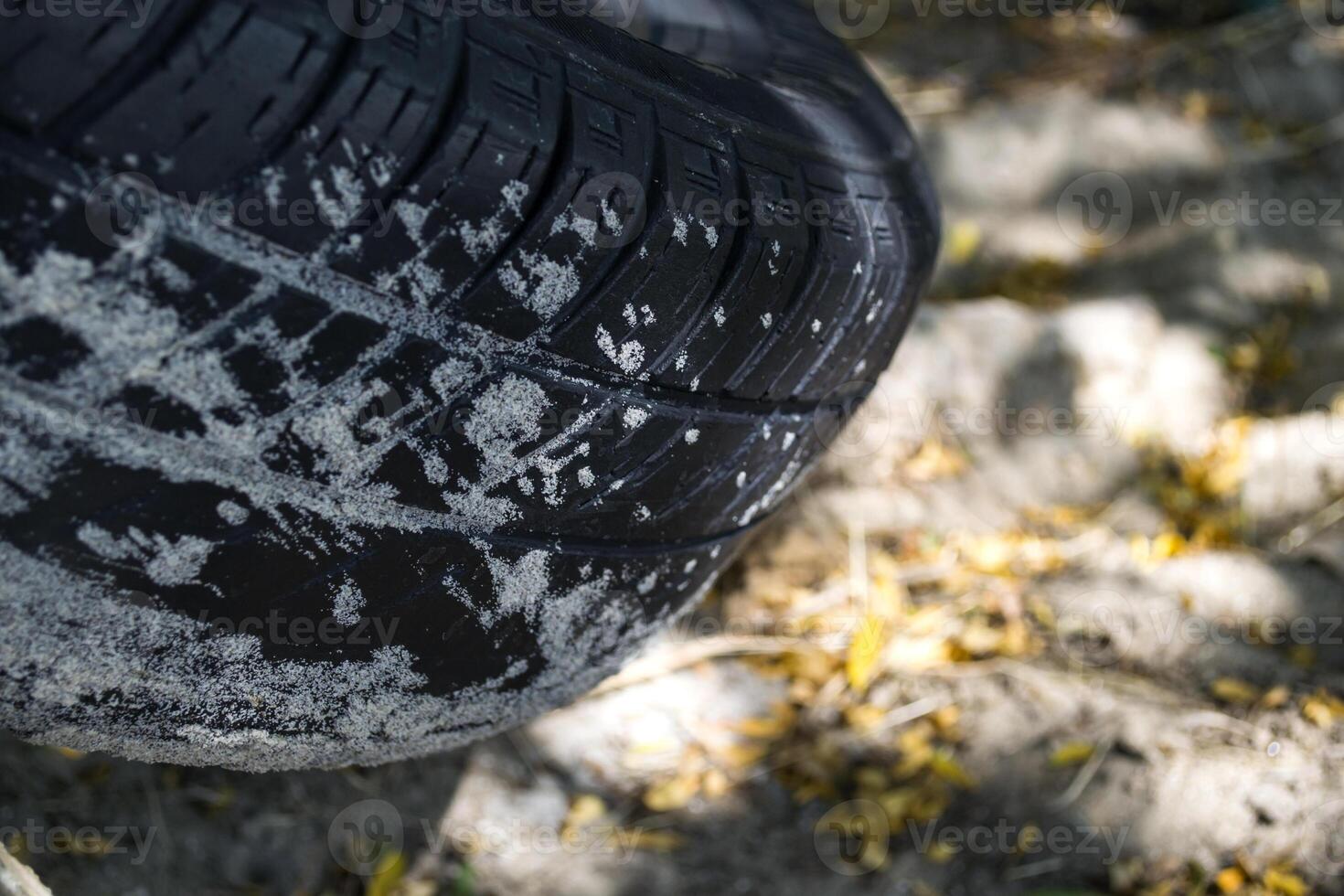 A rubber tire covered by sand, macro shot. photo