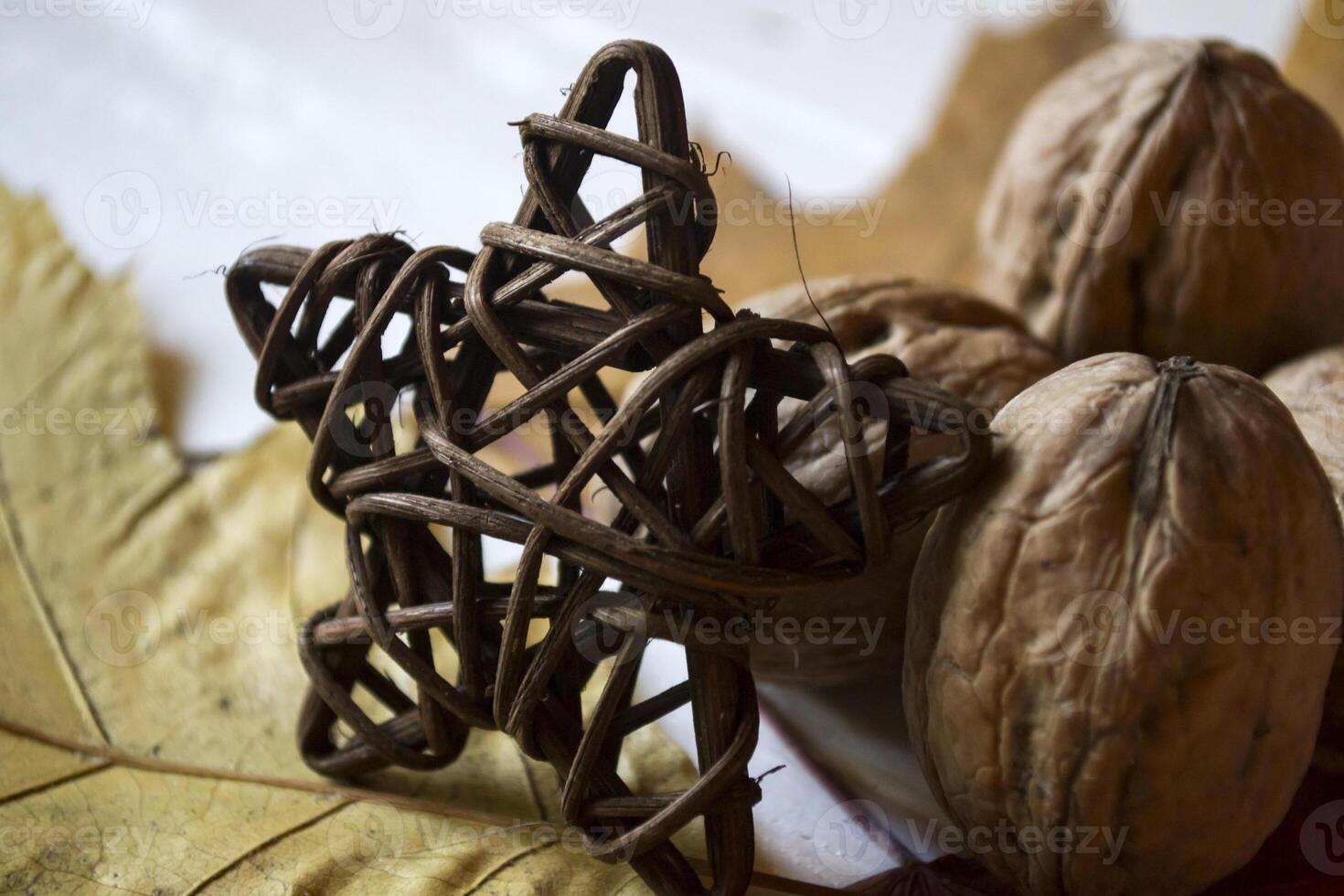 The walnuts and autumn leaves. Beautiful autumn background. Golden fall. photo
