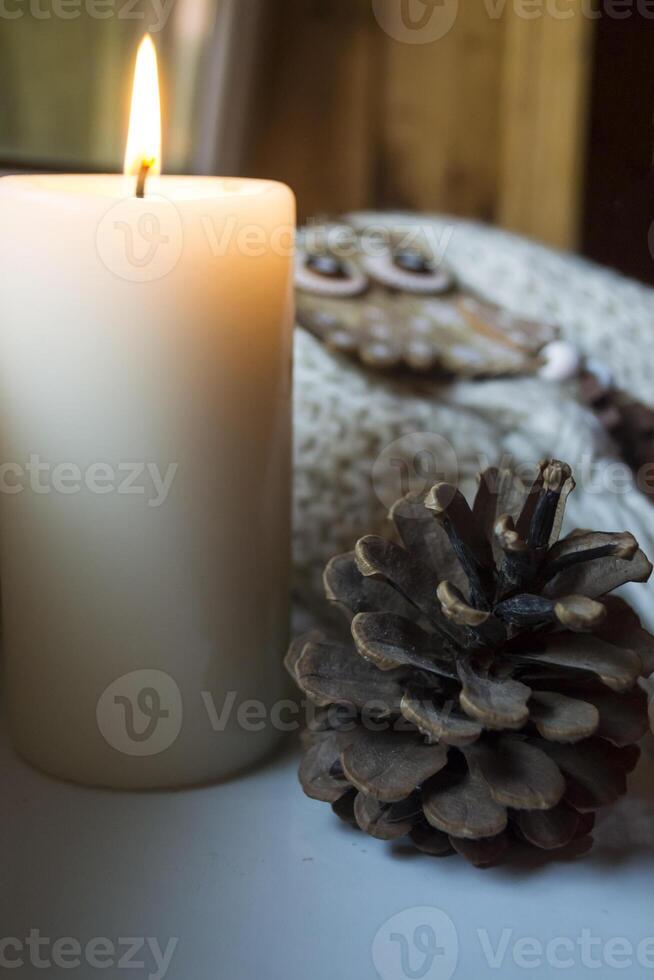 Burning candle and christmas decoration. photo