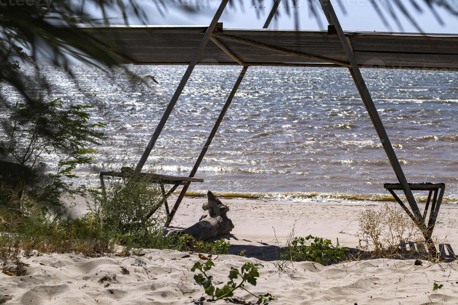 A bower with benches on the beach. Beautiful seascape. The place for rest. photo