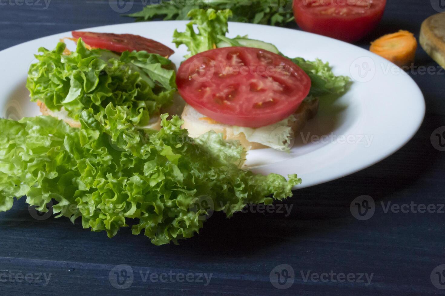 The sandwiches with vegetables on the plate. Vegetarian food. Ingredients for cooking on the table. photo