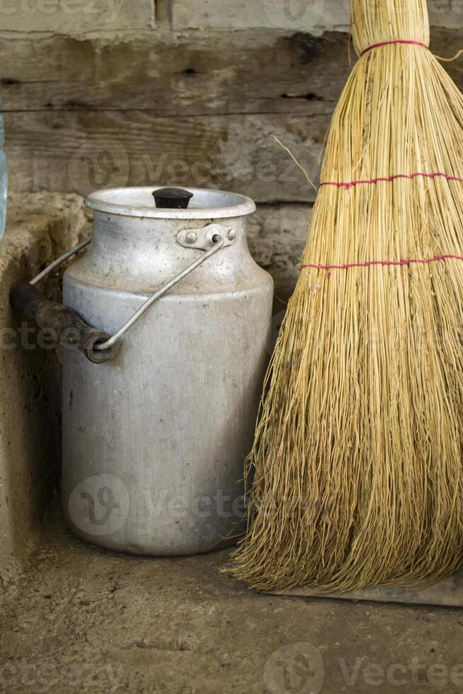 The milk jar and broom. Retro style. photo