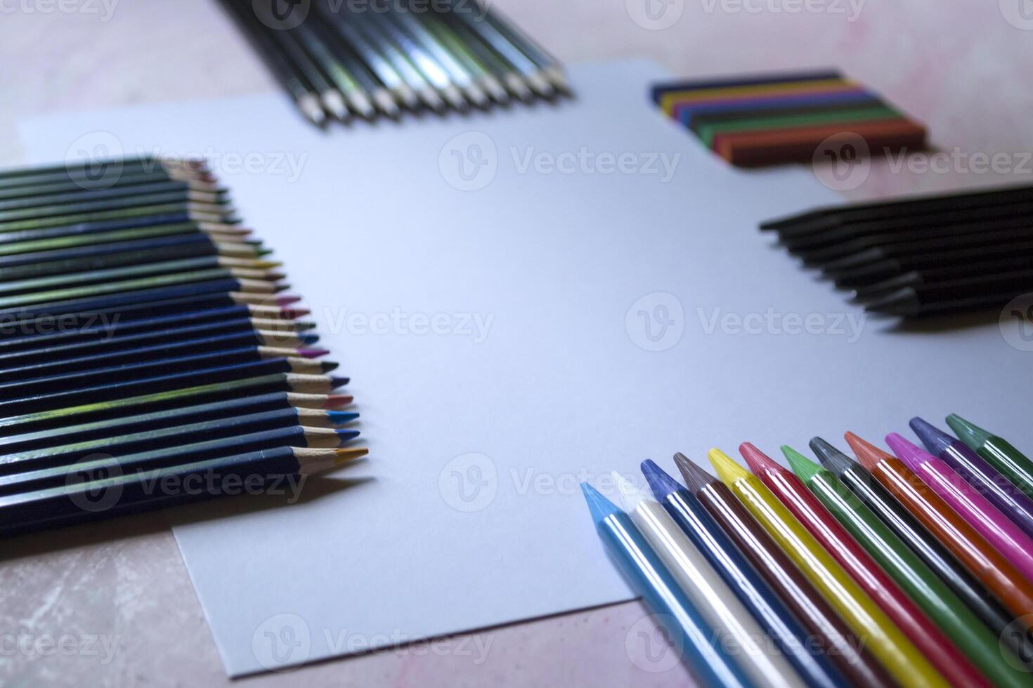 The set of pencils and white paper on the table. photo