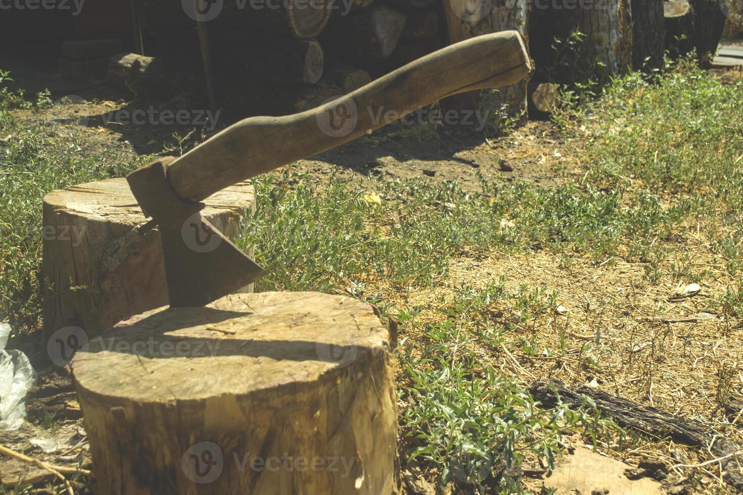 An axe in the wooden stump. photo