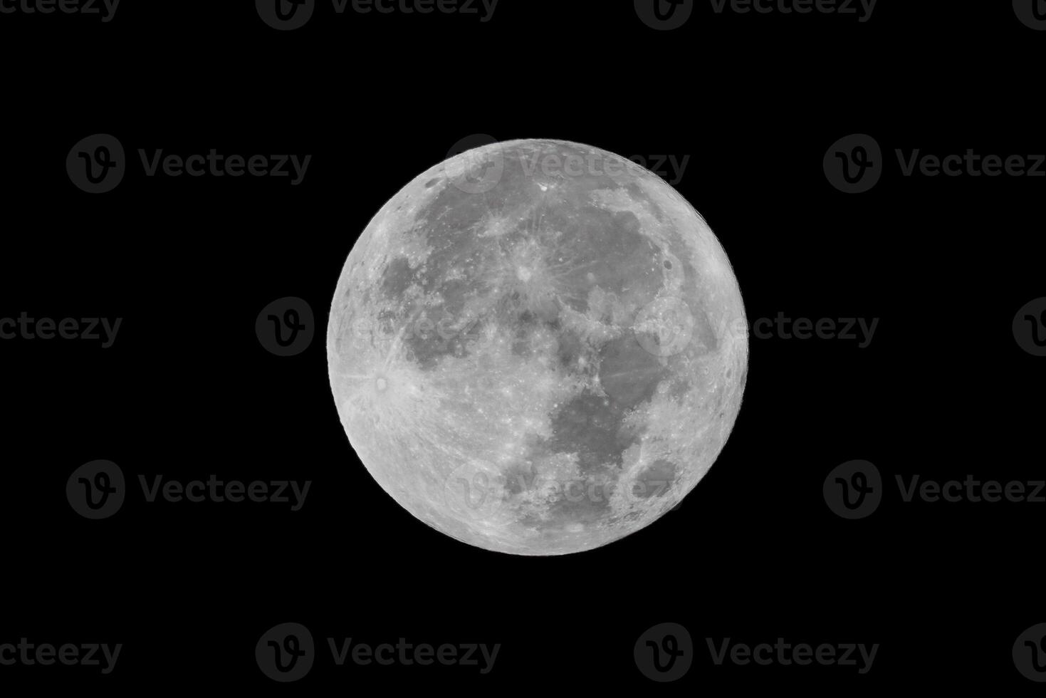 Full moon over dark black sky at night photo