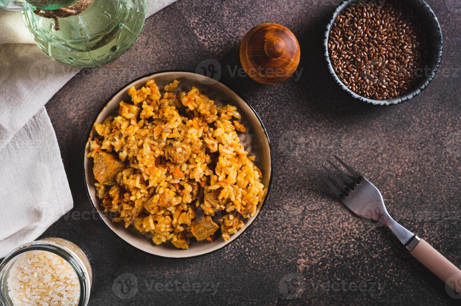 Delicious Asian pilaf with meat on a plate on the table top view photo