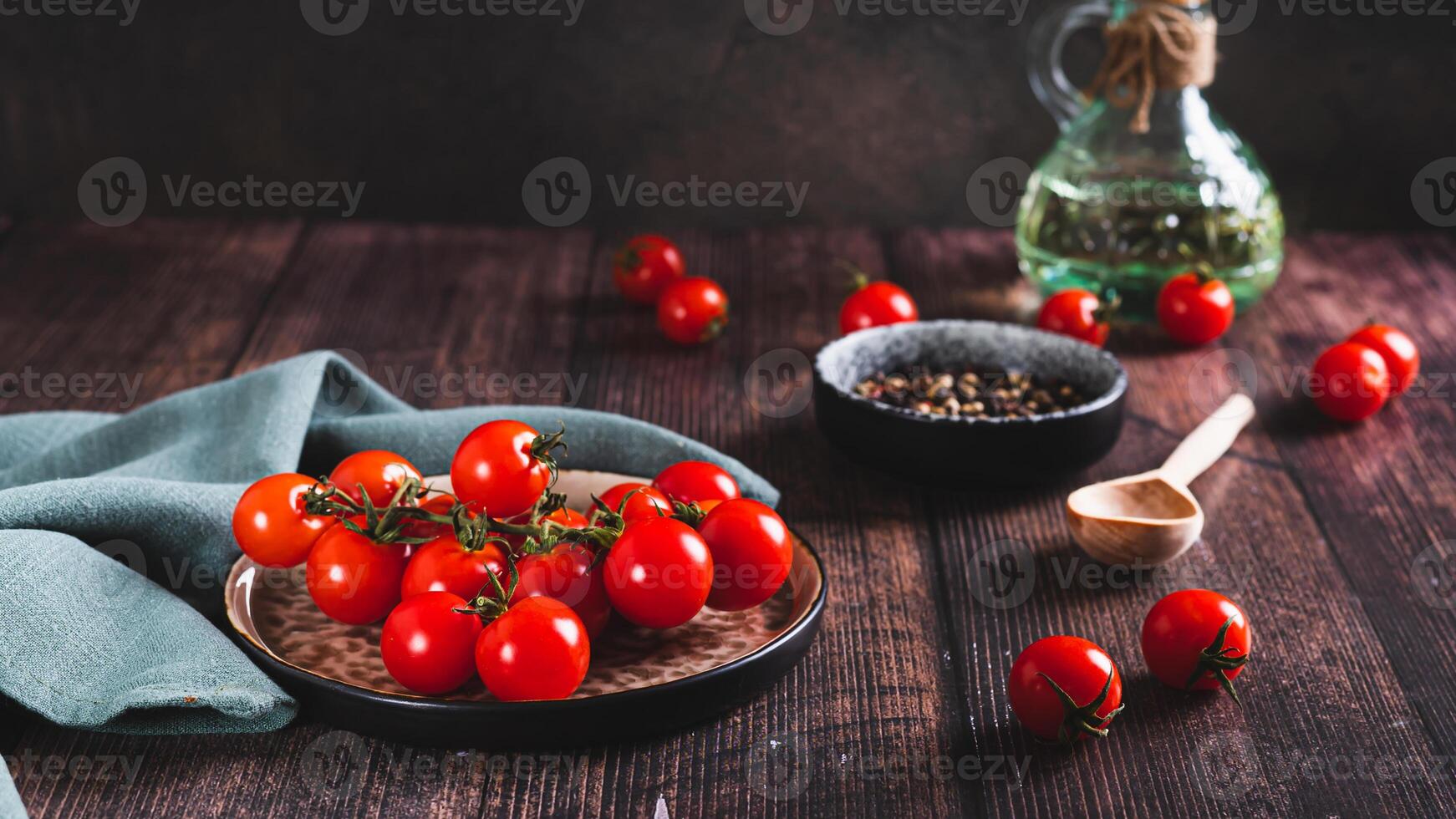 Branch of fresh ripe cherry tomatoes on a plate on the table web banner photo