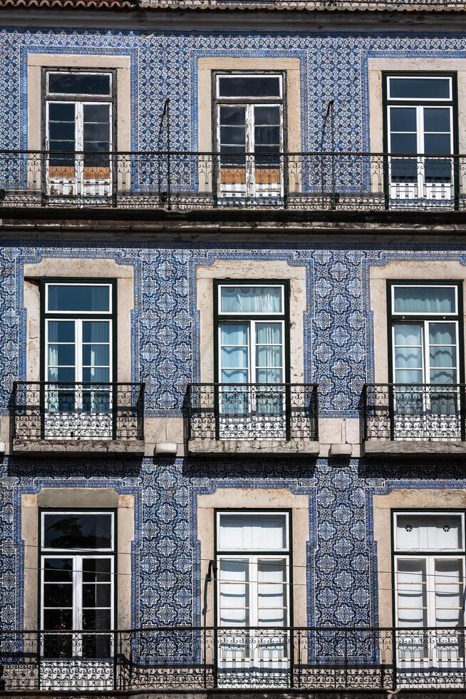 Lisbon buildings with typical traditional portuguese tiles on the wall in Lisbon, Portugal photo