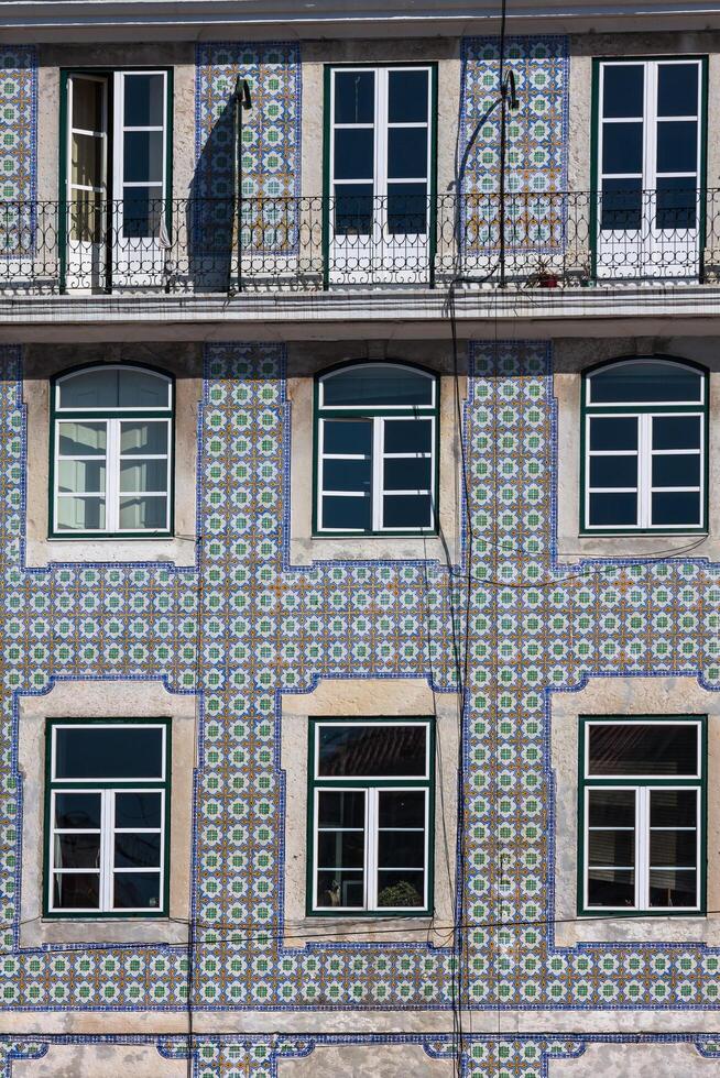 Lisbon buildings with typical traditional portuguese tiles on the wall in Lisbon, Portugal photo