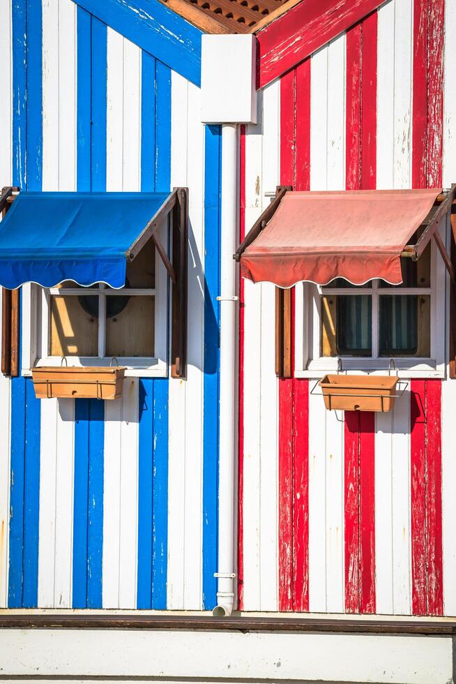 Colorful striped fishermen's houses in blue and red, Costa Nova, Aveiro, Portugal photo