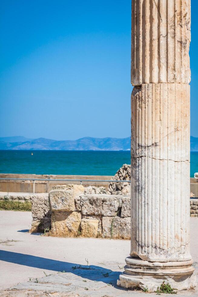 Ancient ruins at Carthage, Tunisia with the Mediterranean Sea in the background photo