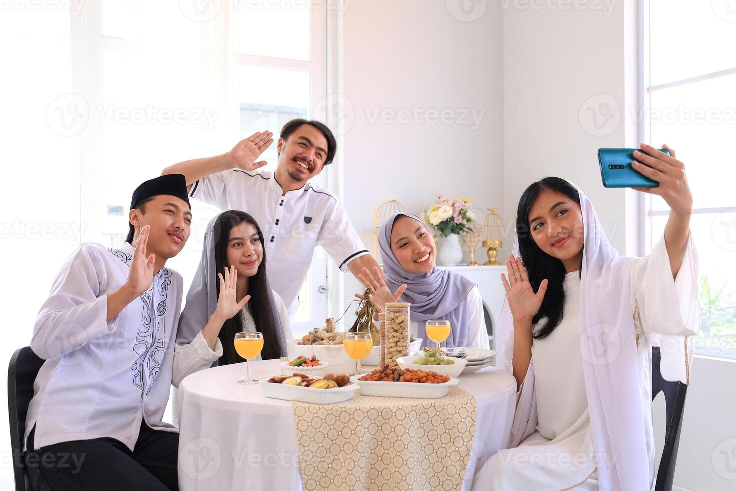 A Group of Friends Taking Selfie Photo during Eid Al Fitr Celebration