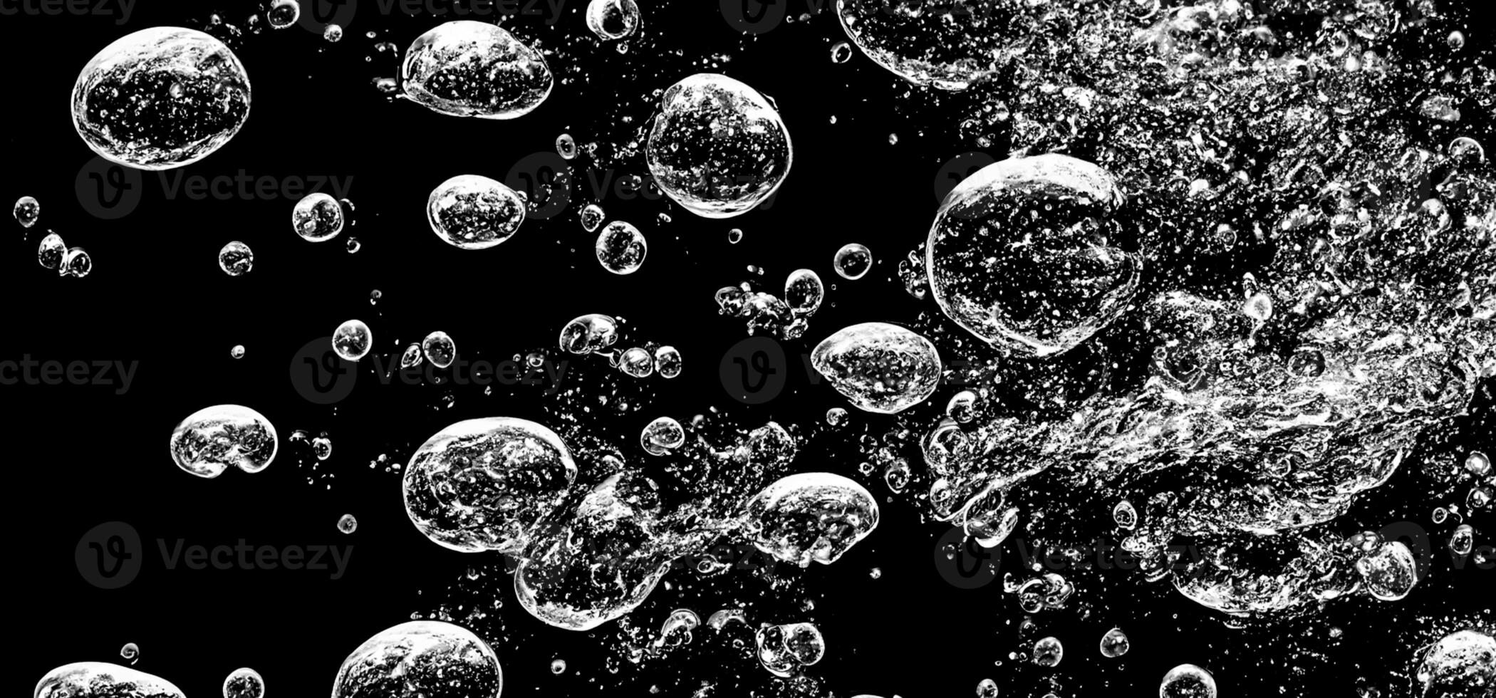 Soda water bubbles splashing underwater against black background. photo