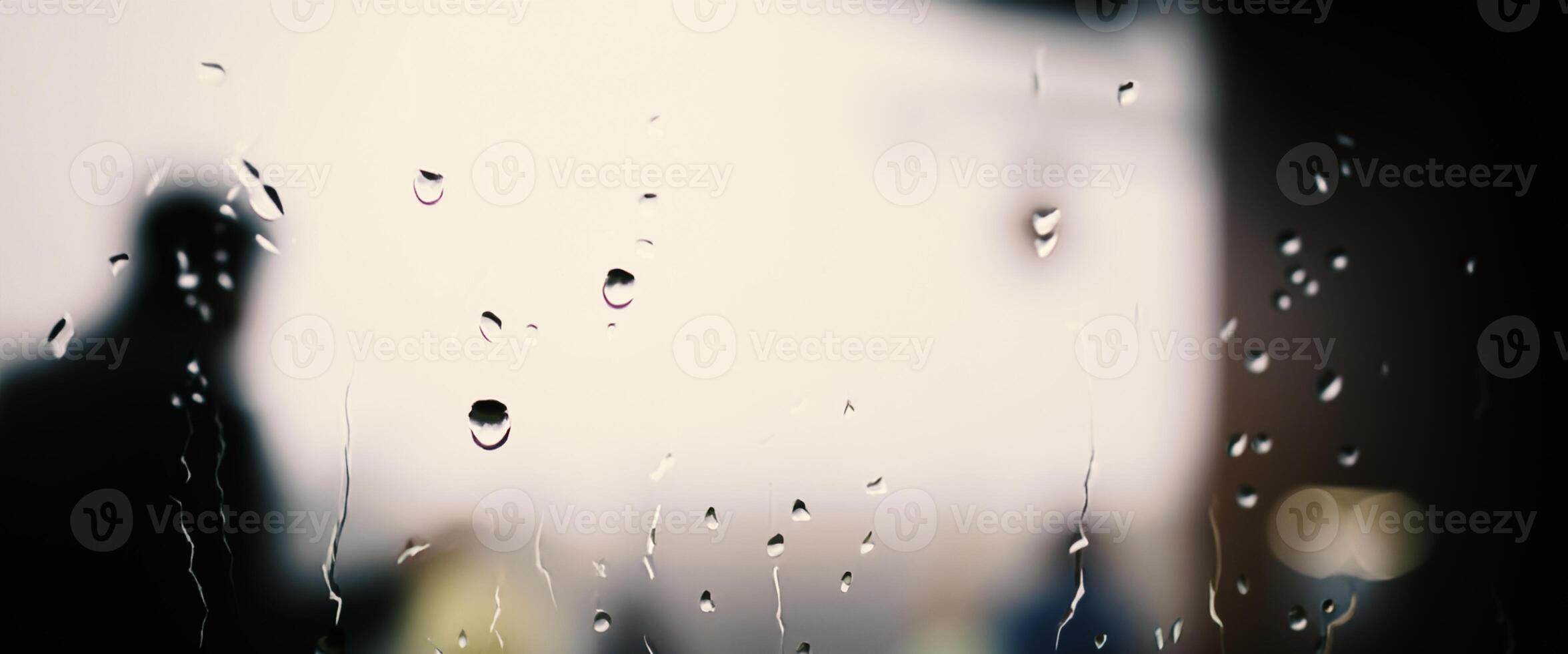 Rain drop on window glass of coffee shop and blurry city life background. Rainy season and blurry people city day life or bokeh night lights outside window. Coffee shop window covered with rain water photo