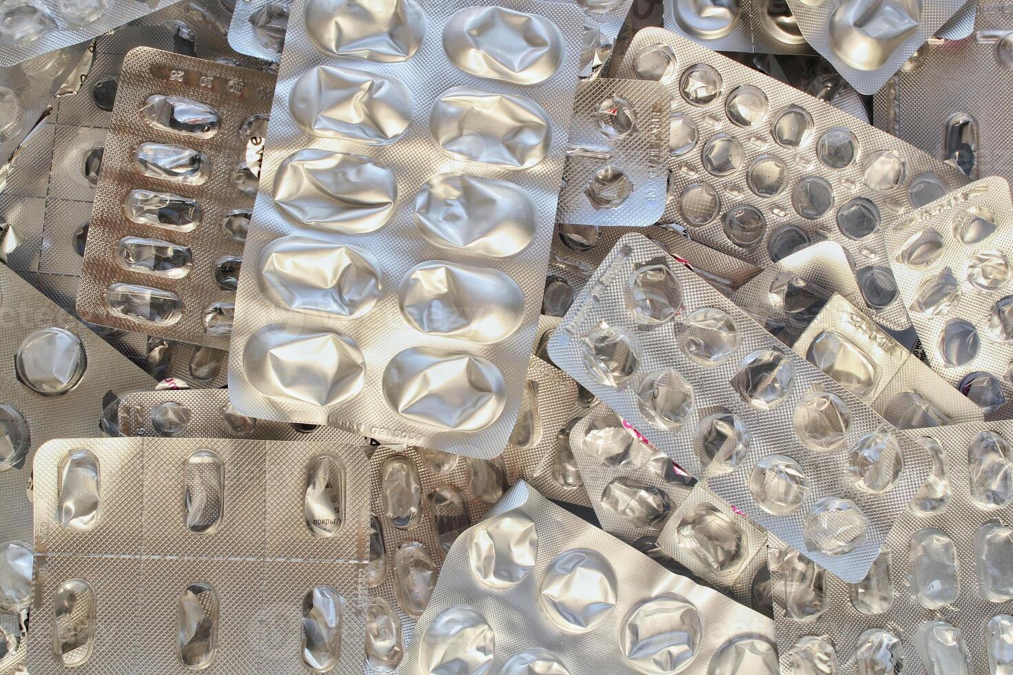 Pile of empty pill blister packs. Treatment and medication concept. Empty blister packages for recycling. Separate garbage sorting. Close up of clinical waste. Reducing medical waste disposal photo