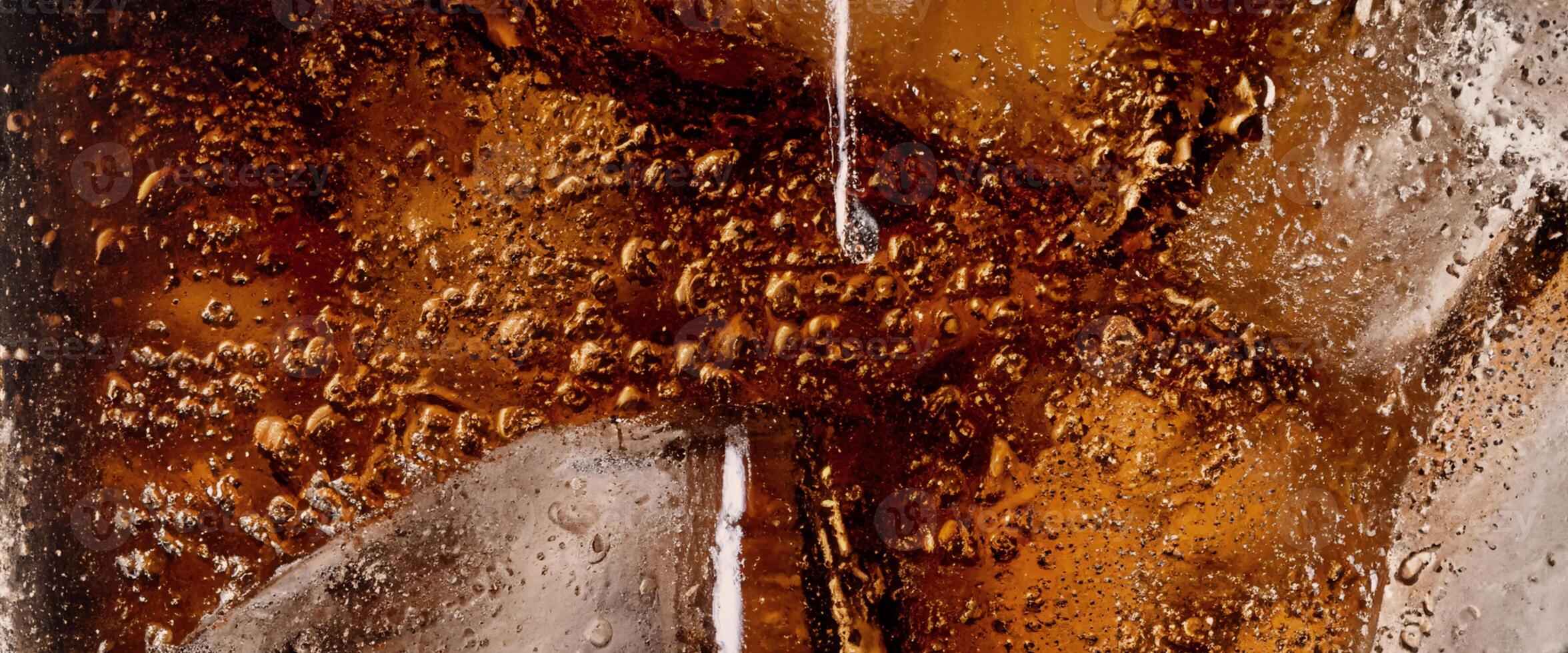 Cola soda and ice splashing fizzing or floating up to top of surface photo