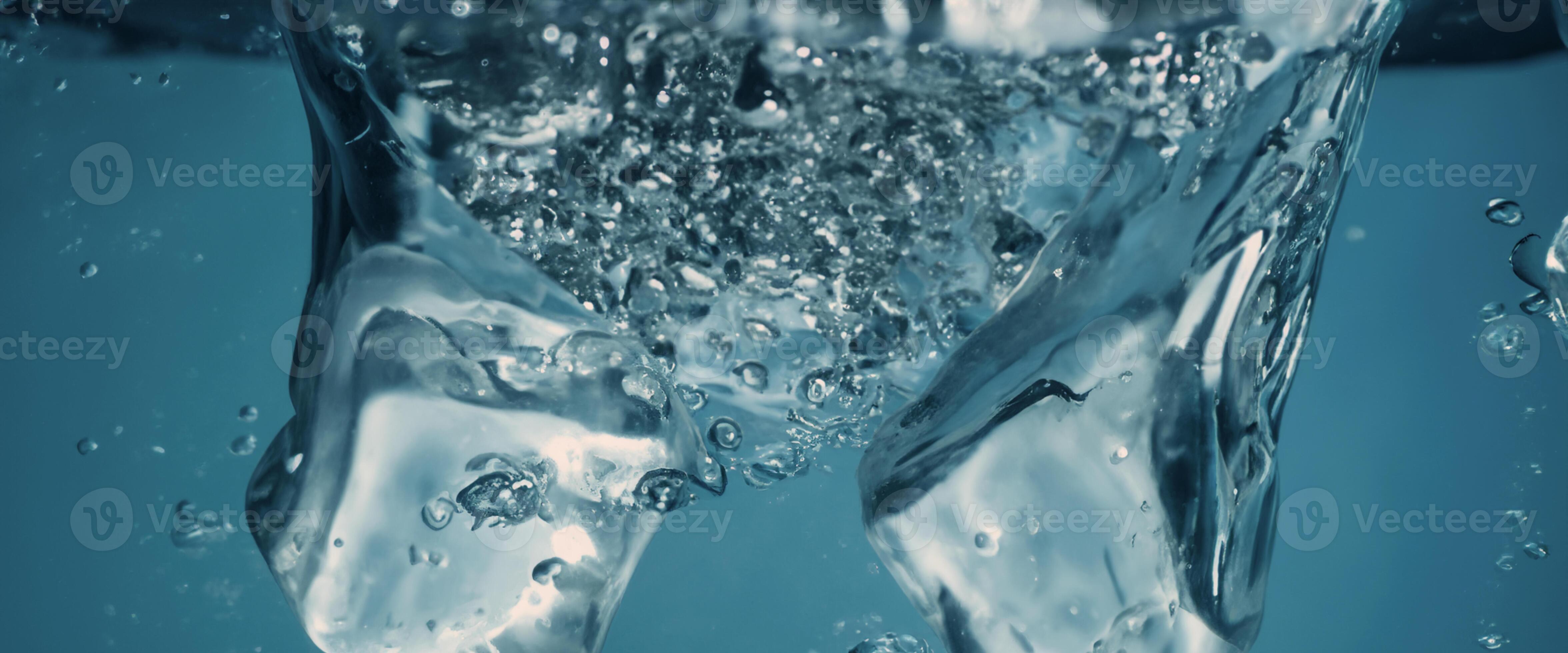 Water splashing and ice cube. Ice splashing into a glass of water