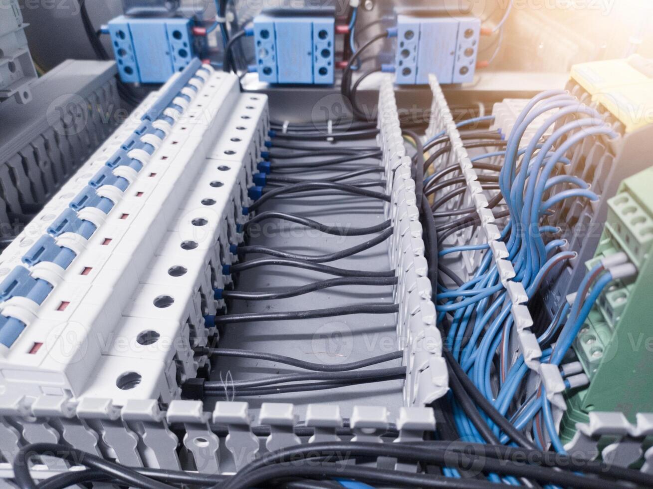 Voltage switchboard with circuit breakers on the panel board. Wire connection board. Electrical background photo