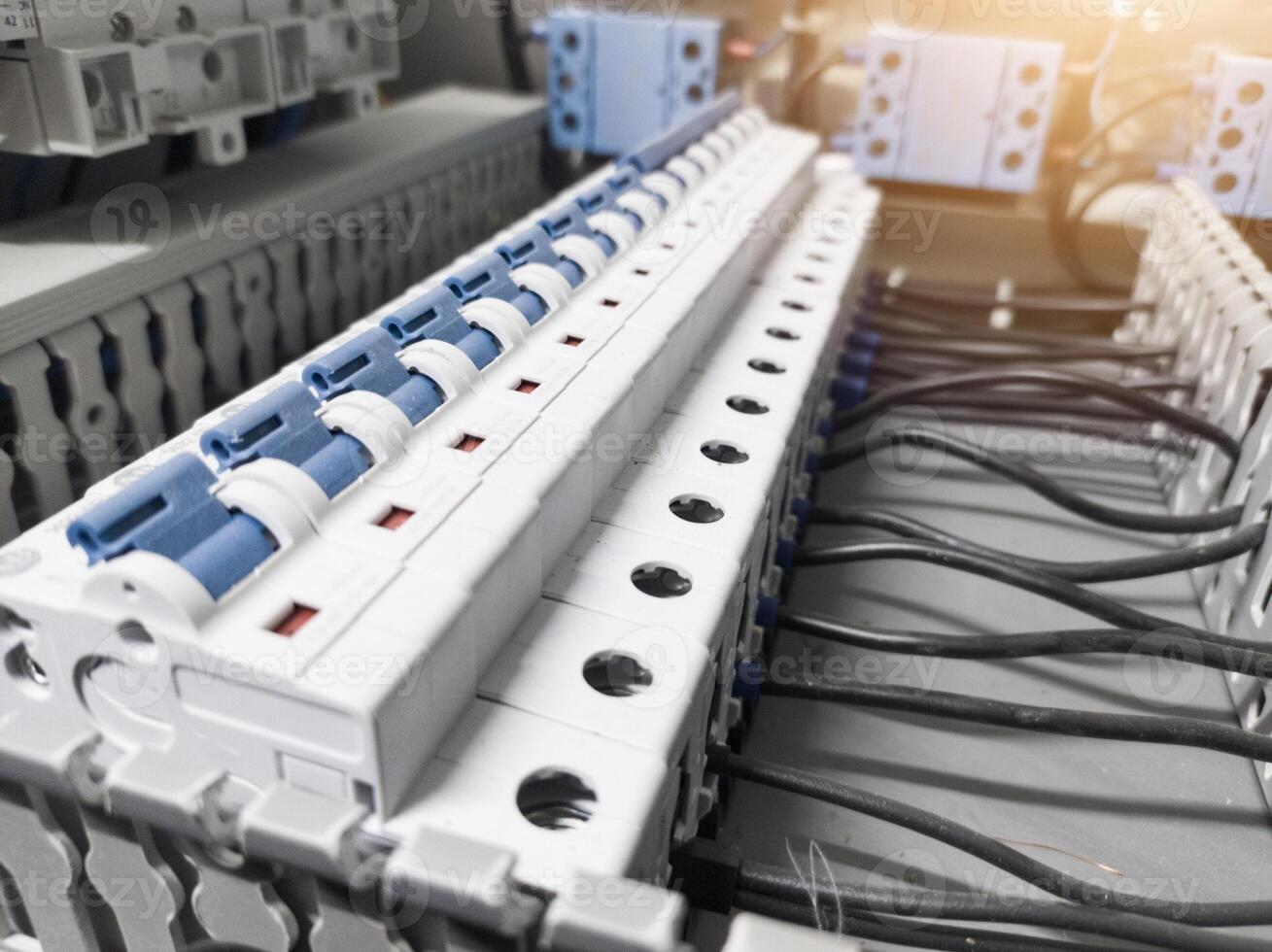 Voltage switchboard with circuit breakers on the panel board. Wire connection board. Electrical background photo